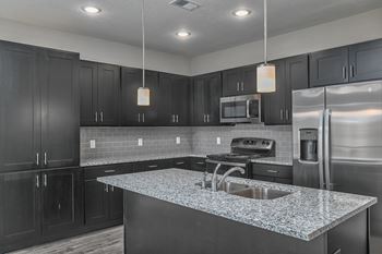 a kitchen with stainless steel appliances and granite counter tops
